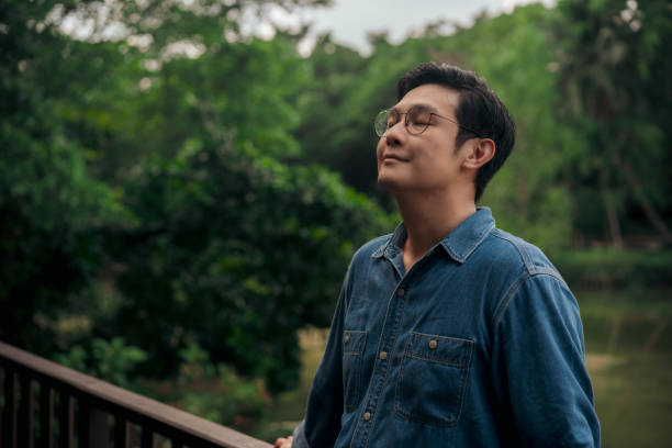 Adult Man Relax and breathing fresh air at park in the weekend. 