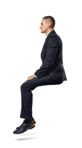 A businessman in profile in sitting position isolated on the white background. Business and management. Poses and gestures. setting this position is the best position for relaxation therapy.