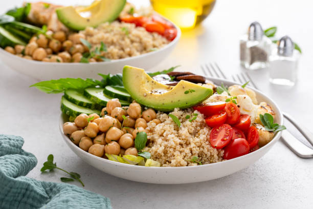 Healthy high protein vegan plant based lunch bowl with mushrooms, roasted cauliflower, herbed chickpeas and quinoa