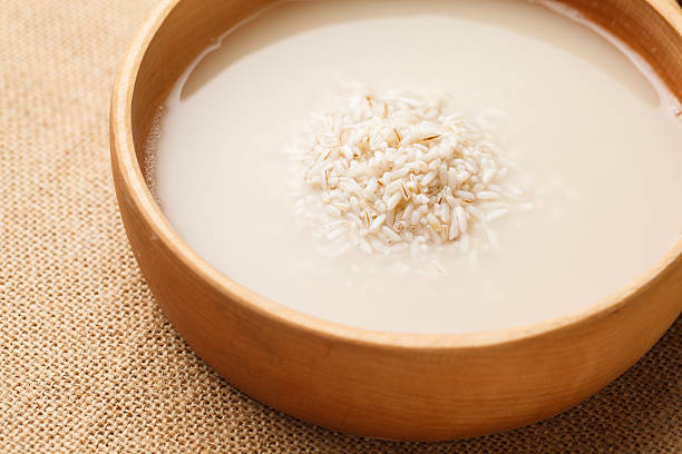 Wash rice in wooden bowl for making rice kanji