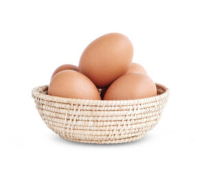 Five fresh chicken eggs in a wicker basket isolated on white background, clipping path.