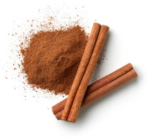 Cinnamon spice sticks and heap of powder isolated on white background, top view