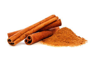 Cinnamon sticks and powder on white background