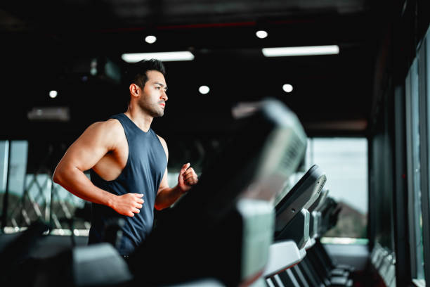 Young Asian Man Running on Treadmill - Fitness Gym Exercise