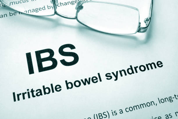 Paper with words Irritable bowel syndrome (IBS) and glasses.